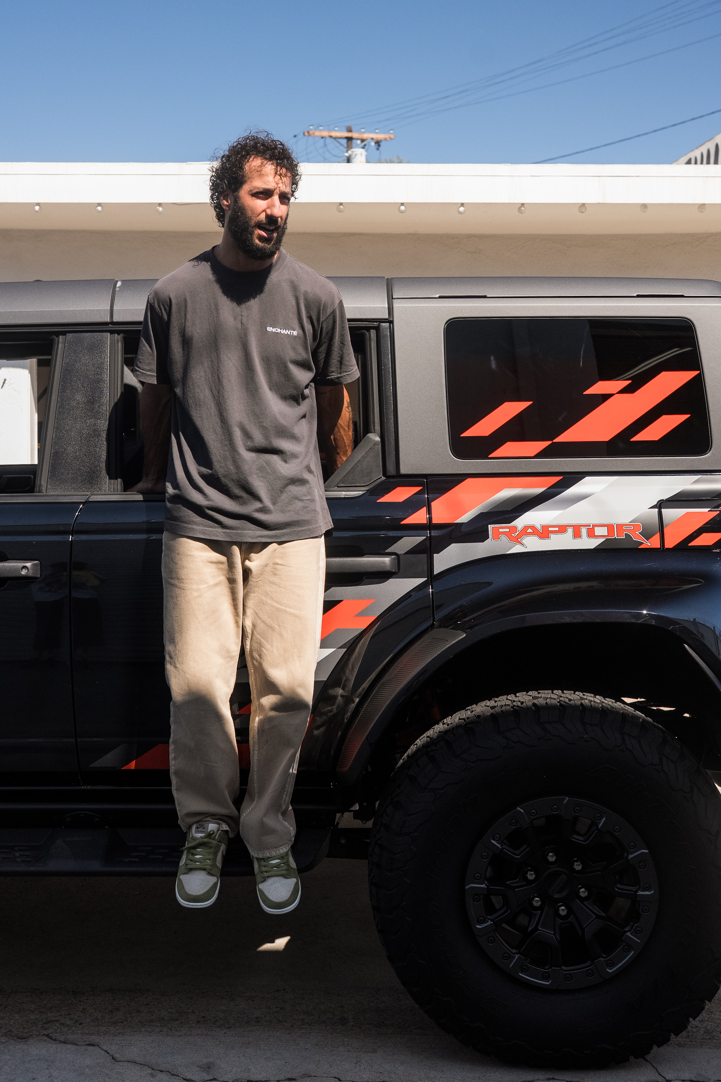 Racer Daniel Ricciardo poses with a Ford Raptor